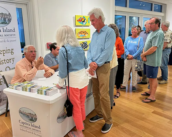 People wait to have the book Tales of an Island Innkeeper signed by author and CIHS board member Tony Lapi